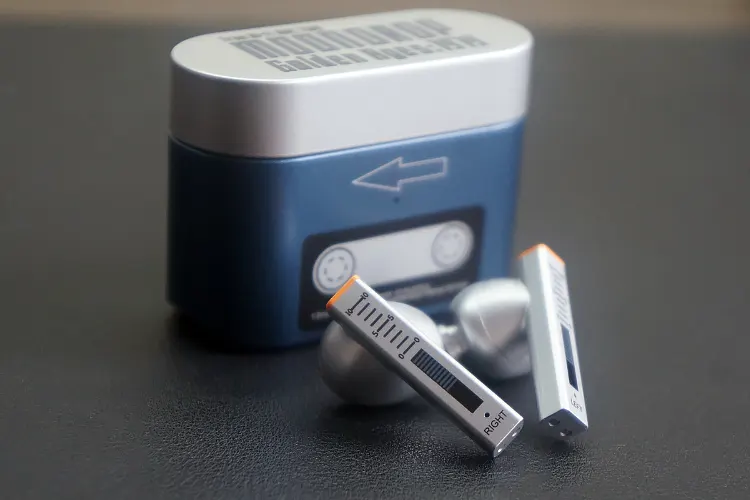 MOONDROP Golden Ages earbuds beside cradle